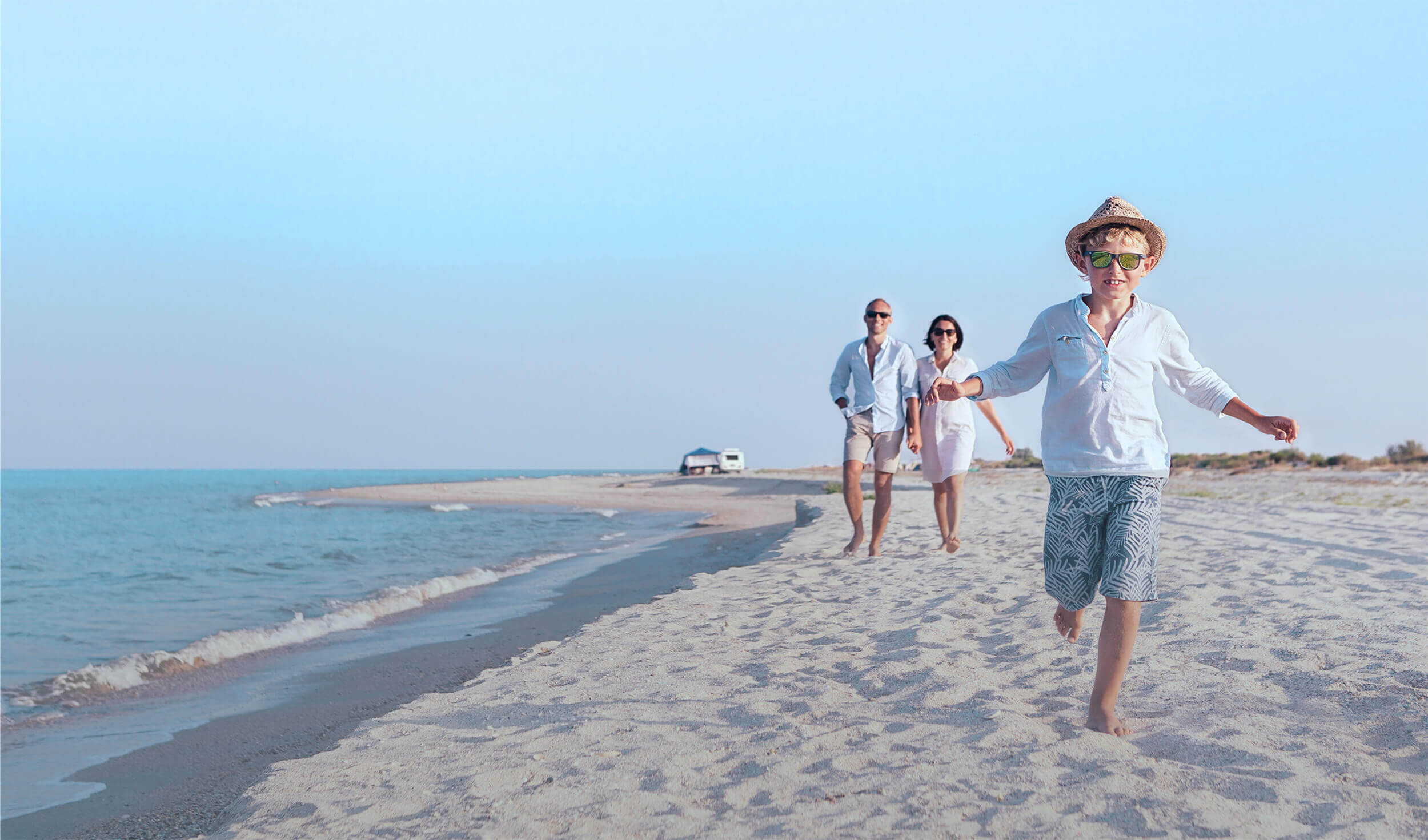 Family walking together on the beach