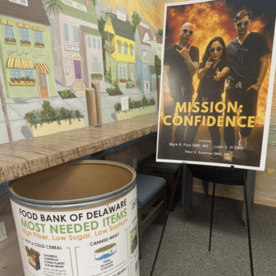 Food Bank of Delaware donation bin next to a Mission: Confidence poster on an easel