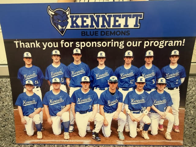 Kennett Blue Demons baseball team photo on a board reading Thank you for sponsoring our program!